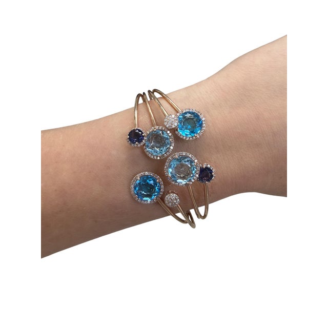 Consisting of four round mixed cut blue topaz measuring approximately 10.00 mm round, two round mixed cut iolites...