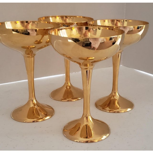 An exceptional set of four vintage champagne coupes by International Silver Company, beautifully rendered in a lustrous...