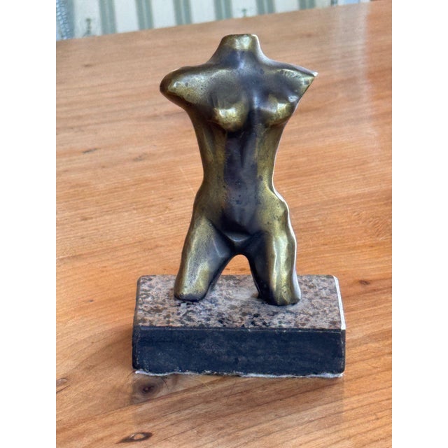 Small bronze female nude torso, simplified and smoothly modeled, with squared shoulders, a softly curved waist and hips,...