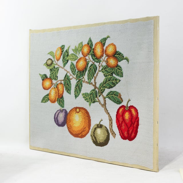 This vibrant vintage needlework piece features a meticulously botanical still life, showcasing a slender branch laden with...