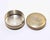 Small circular silvered metal box of clean modernist form with a fitted lid and engraved monogram to the top. The...