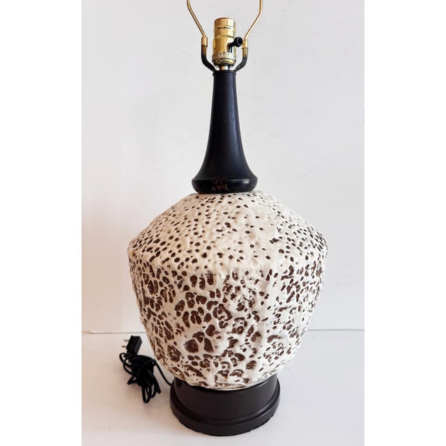 Mid-century Modern Lava-Textured Glaze Ceramic Table Lamp Offered for sale is a mid-century wood and ceramic table lamp...