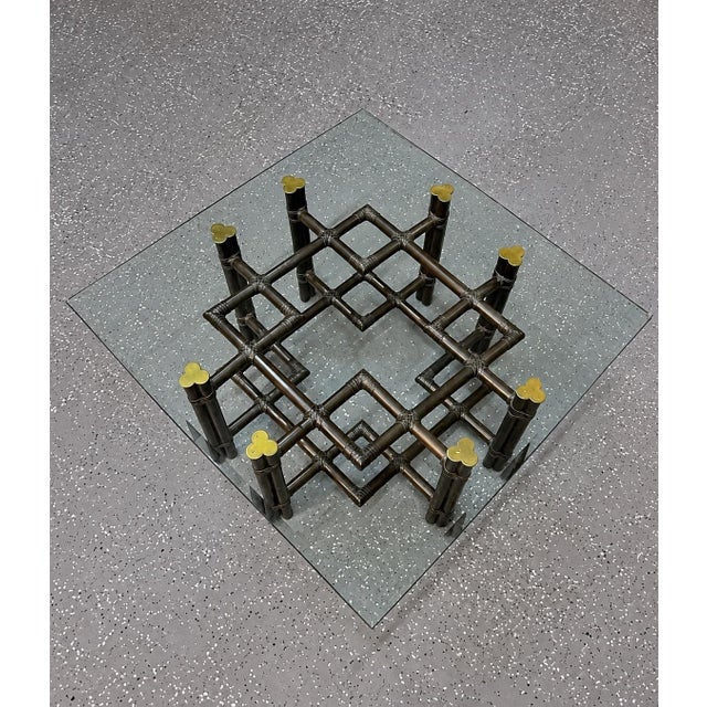 1970’s McGuire model 66S turned hardwood brass and glass coffee table. The wood is bound with rawhide and topped with...