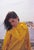 Minnie Cushing In Yellow by Toni Frissell Model Minnie Cushing wearing a yellow waterproof jacket stands by the ocean,...