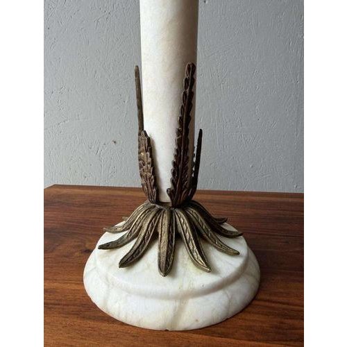The proportions make these lamps instantly recognizable. A heavy alabaster base, a slender column, and atop it a large...