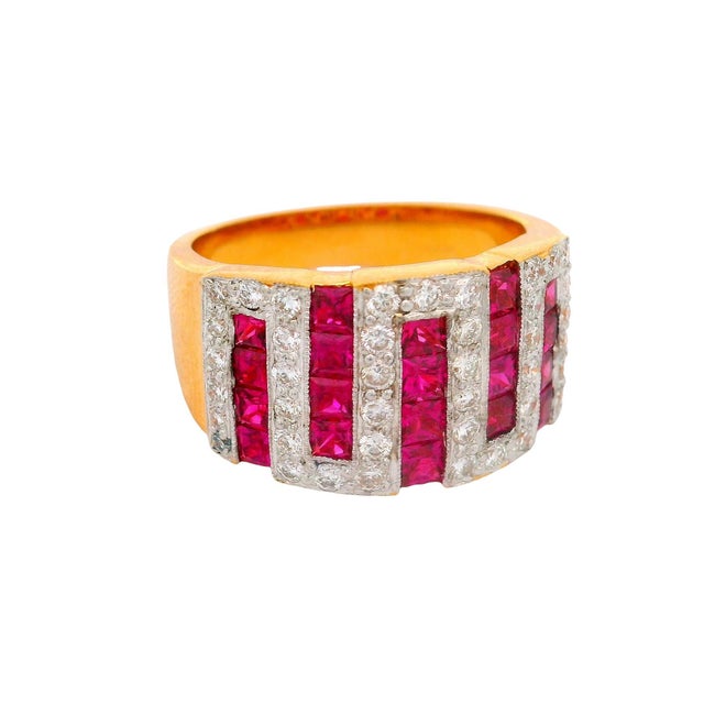 A bold band ring featuring 1.63 carats of princess rubies. The rubies exhibit a deep red hue. Accentuating the rubies are...