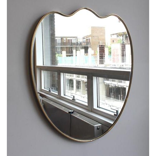 Mid-Century Italian wall mirror with brass frame (circa 1960s). This mirror is simply elegant and characterful in a...