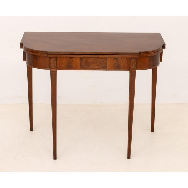 George III Style Mahogany Flip-Top Table, with string inlay and gate leg. 29" H x 36" W x 17.5" D. Provenance: From an...