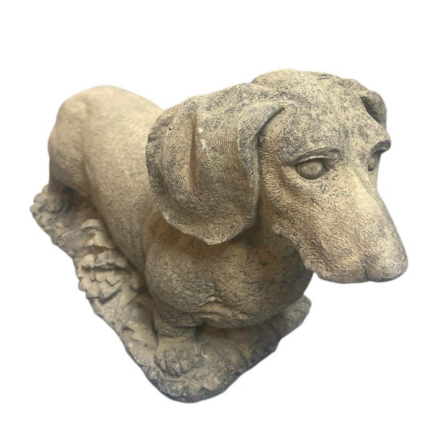 This charming vintage garden statue captures the distinctive silhouette and alert expression of a Dachshund in substantial...