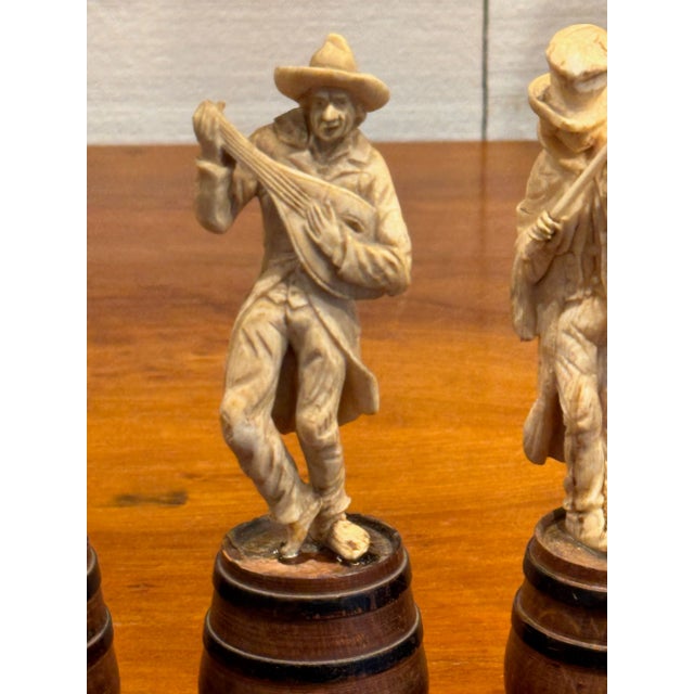 This is a nicely carved set of musicians. They are all standing on barrels.