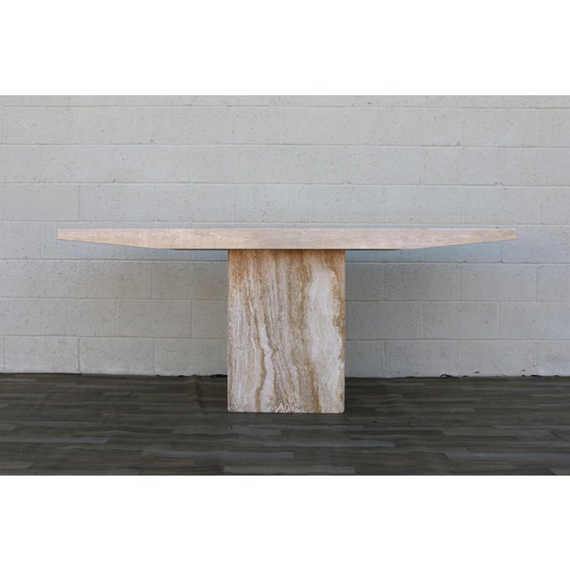 Striking vintage Italian Postmodern console table, circa 1970s, crafted entirely from beautiful beige travertine stone....
