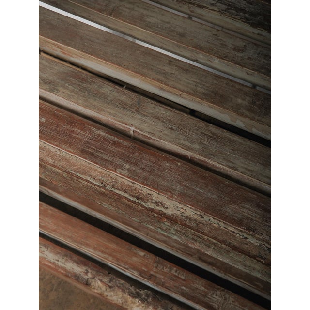 This vintage wooden shelving unit features a tall, open-frame construction with four fixed slatted shelves and a sturdy...