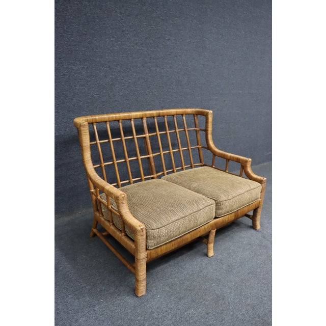 Braxton Culler split reed and bamboo settee with an exposed lattice back, wrapped reed frame, and loose seat and back...