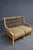 Braxton Culler split reed and bamboo settee with an exposed lattice back, wrapped reed frame, and loose seat and back...