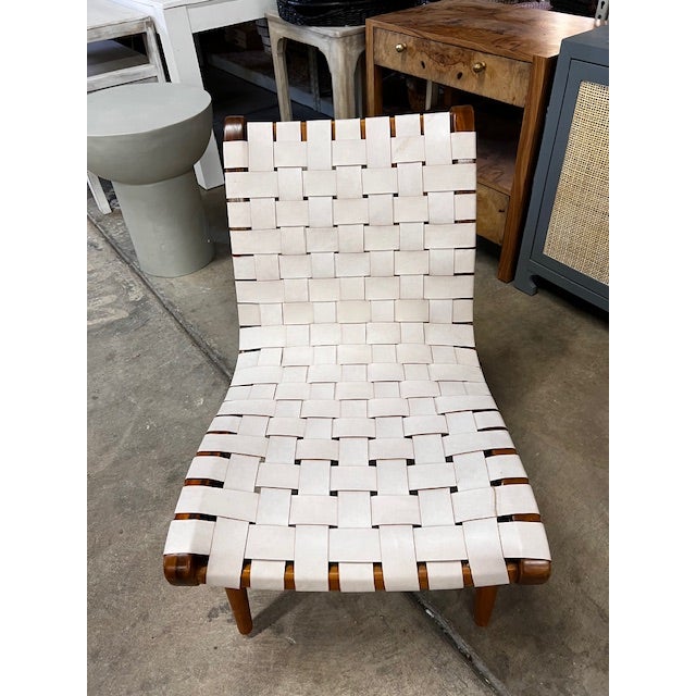 Made of teak wood with untanned leather, this chair is the perfect accent piece in a living room, bedroom, or study.