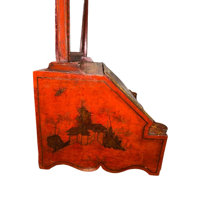 A striking Chinese export dressing mirror in richly decorated red lacquer, featuring finely hand-painted and gilt...