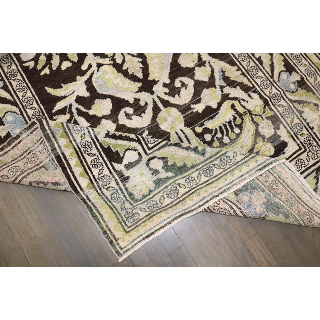 An intermediate-size Persian Malayer Formal rugs featuring pops of green