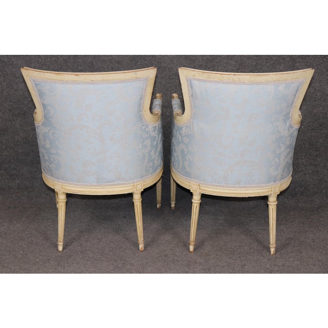 Elevate your interior with this exquisite pair of French Louis XVI style bergère chairs, masterfully crafted with elegant...