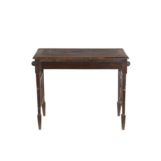 This Vintage Indian Teakwood Table is handcrafted from solid teakwood, featuring a rectangular top supported by tapered...