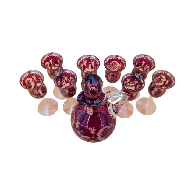 Red cut to clear decanter with matching stopper and 8 glasses with twisted clear crystal stems. marked 86 or 98 I can't...