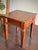 A beautifully proportioned Georgian Revival mahogany lamp table featuring a paneled top, molded apron, and architectural...