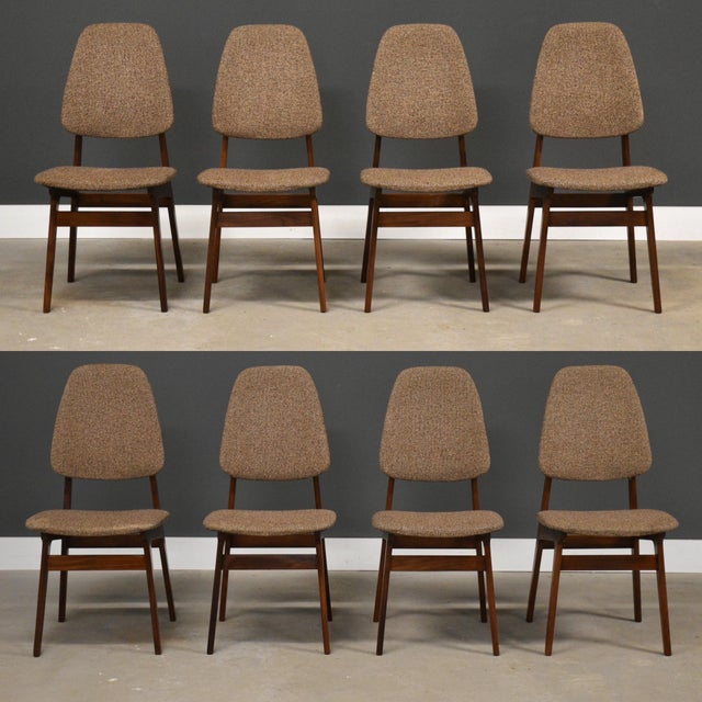 A set of eight mid century modern teak high back dining chairs with beige upholstered backs designed by Bruk Sorheim for...