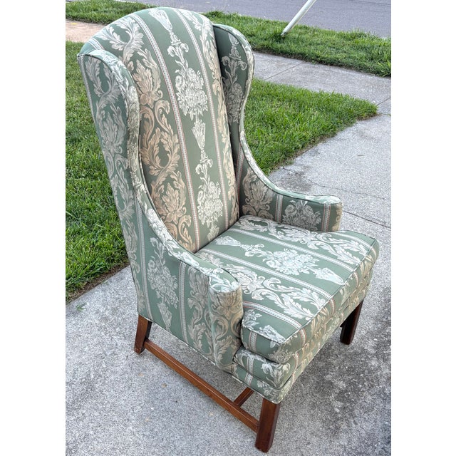 Beautiful midcentury wingback chair with alternating stripes and neoclassical themes of overflowing urns and scrolling...
