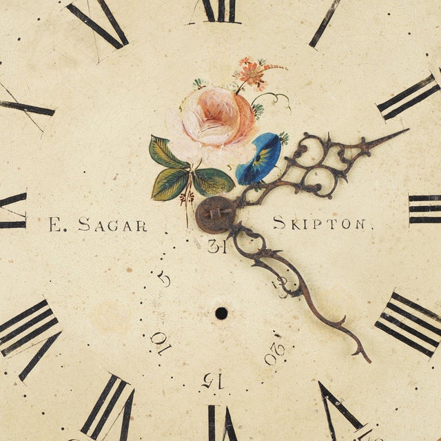 Japanned steel clock face with English roses in the spandrels and center with an Arabic numeral dial. The clock face...