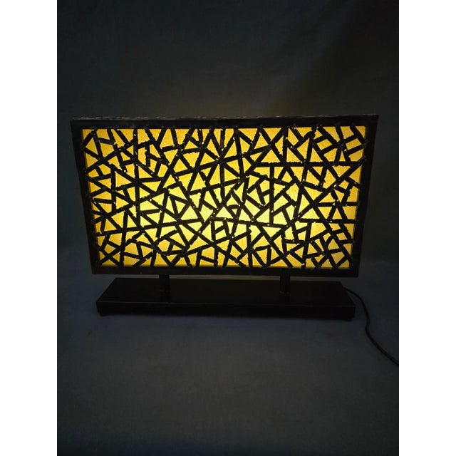 This is an amazing example of mid century lighting. A brutalist table that can be viewed from both sides. The geometric...