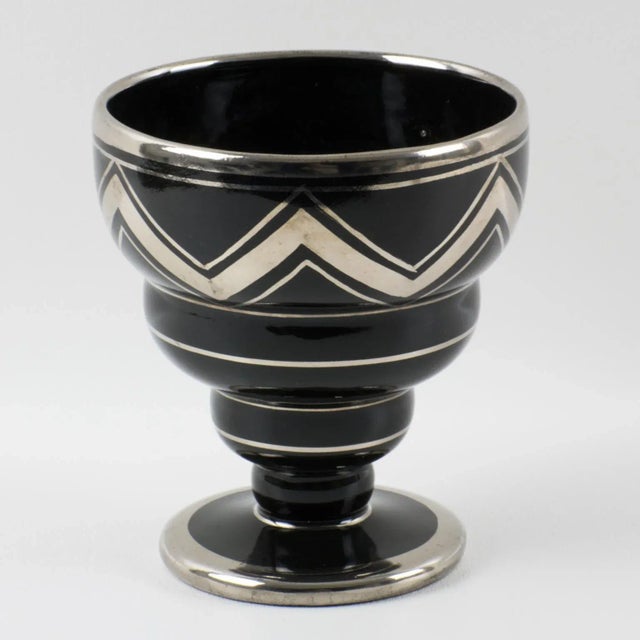 Ceram, Rouen, designed this stylish 1930s French Art Deco black ceramic vase. The decorative piece features silver deposit...