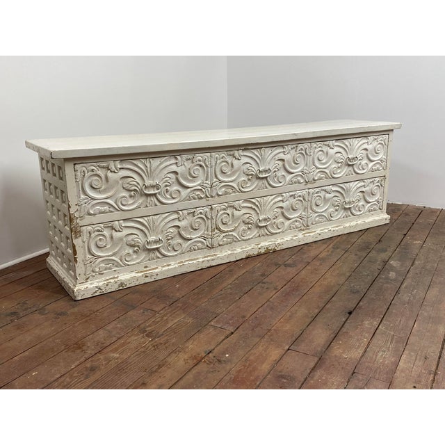 A large rustic six drawer relief carved floral motif dresser. This sumptuous Spanish Colonial style piece features six...
