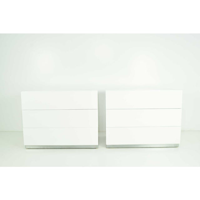 Enhance your bedroom with this stunning pair of Milo Baughman Nightstands in White Lacquer. These nightstands, beautifully...