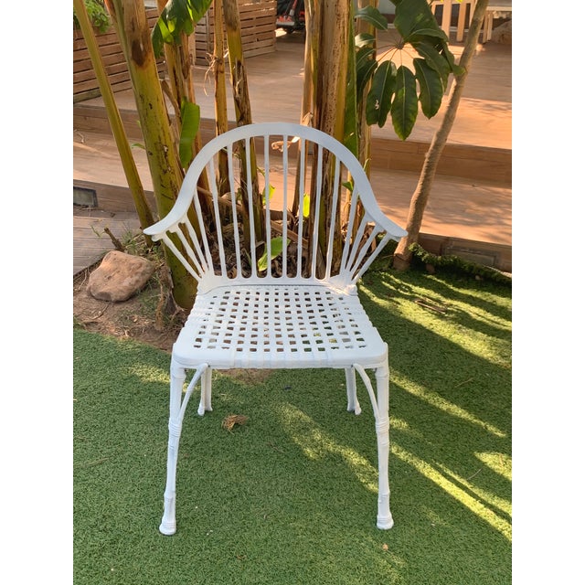 About A Renaissance Revival style figural garden armchair offers cast iron construction with scroll and foliate back...