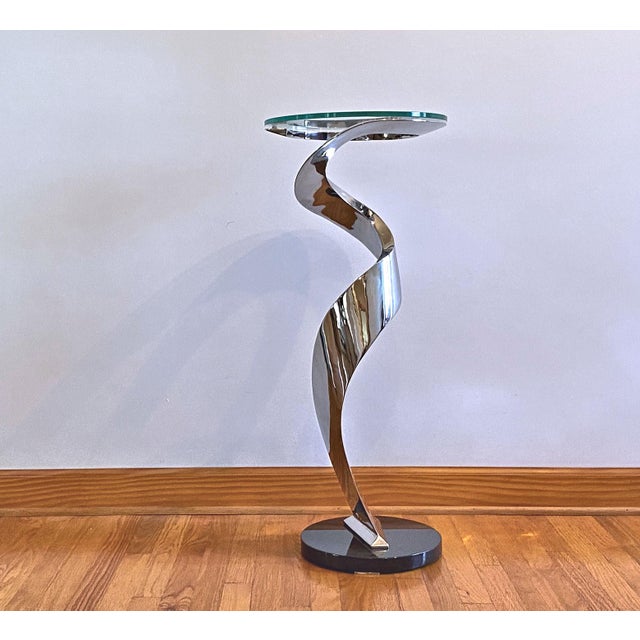 This table is made from 12 gauge and 3/16" welded and polished stainless steel and is an isosceles triangle in cross...