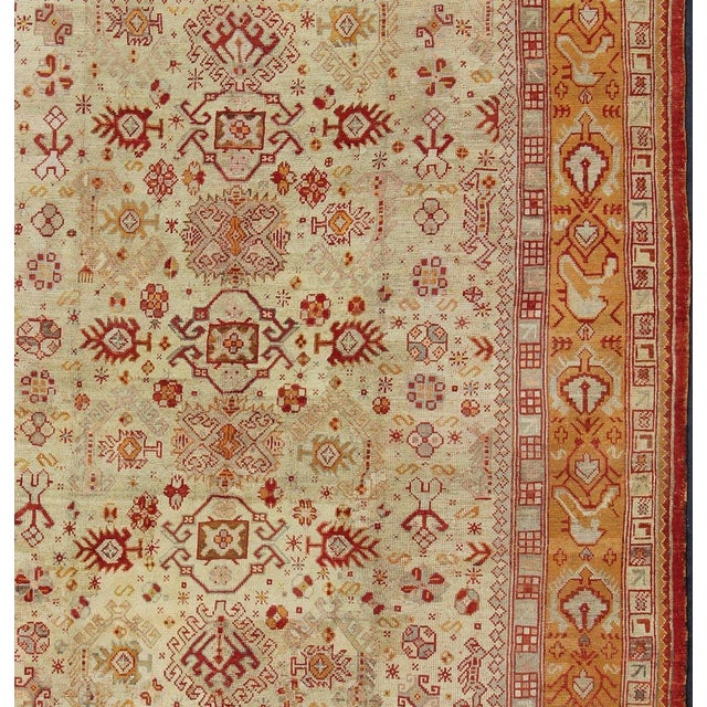 Antique Turkish Oushak Carpet With All-Over Design In Red, Taupe, and Orange. Keivan Woven Arts; rug G-0901, Country of...