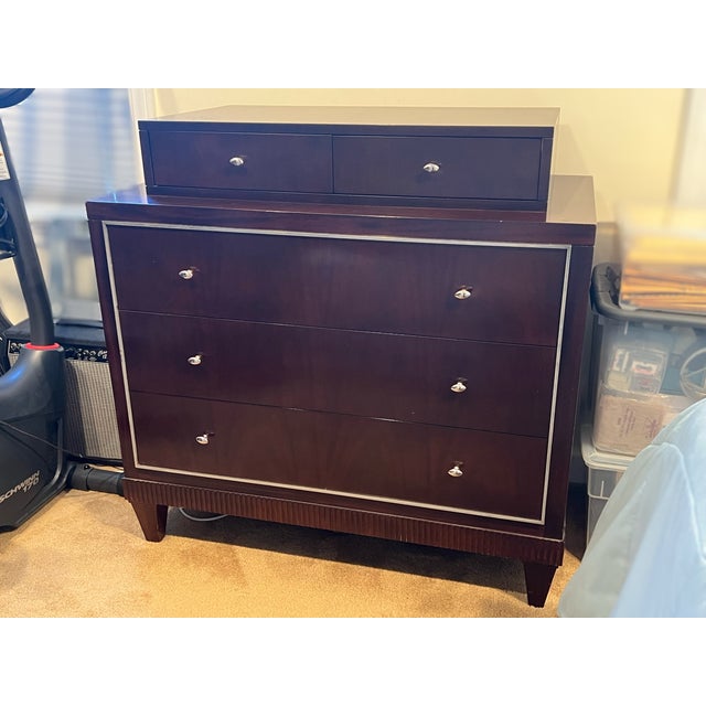 Presenting an authentic Barbara Barry for Baker stepped-top dresser. Finished in a dark wood stain, the piece features a...