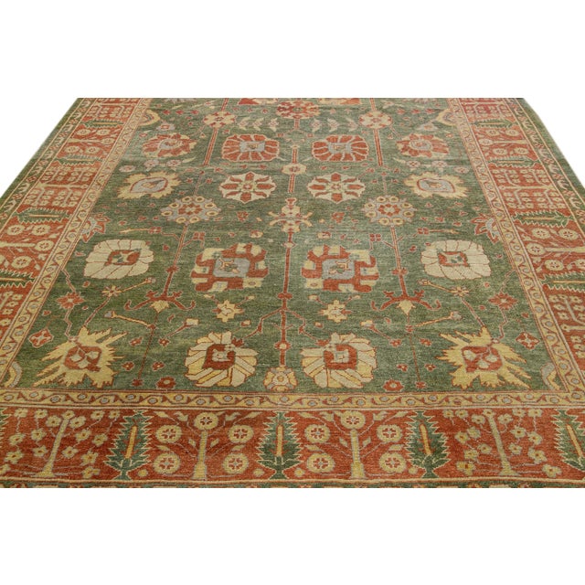 Beautiful modern Oushak hand-knotted wool rug with a green field. This Oushak rug has a brown frame and yellow and gray...