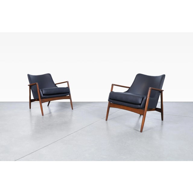 Designed by the legendary Ib Kofod-Larsen and produced by Selig in the 1950s, this exceptional pair of Danish Modern...