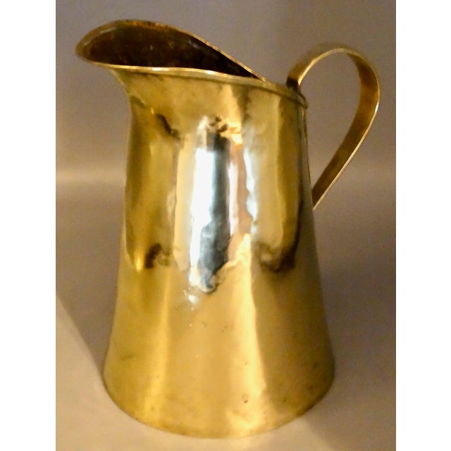 19th-Century French handcrafted brass pitcher. It has a rolled edge, dovetail joined seam and applied handle. This lovely...