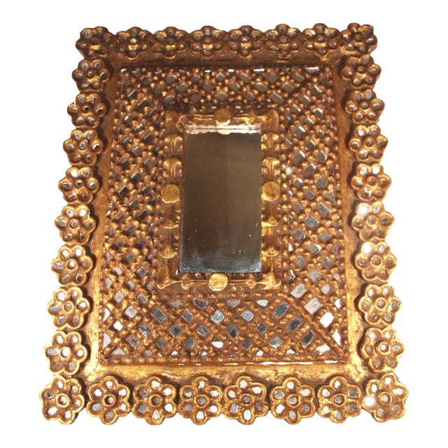 An antique true Spanish mirror in the Moroccan style. Mirror is a raised pyramid shape. Over 300 small mirrors are inset...