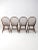 A set of four mid-20th-century Windsor-style dining chairs by Cochrane Furniture. Each chair features a rounded bow back...