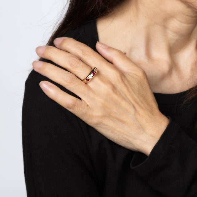 Stylish vintage ruby & diamond band crafted in 14 karat yellow gold. Two diamonds total an estimated 0.25 carats...