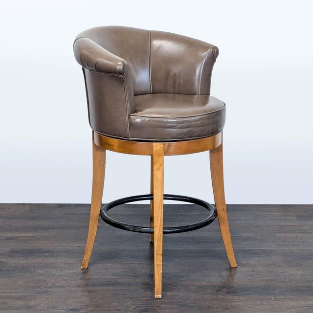 This stylish bar stool features a comfortable brown leather seat with a curved backrest for support. The sturdy wooden...