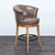 This stylish bar stool features a comfortable brown leather seat with a curved backrest for support. The sturdy wooden...