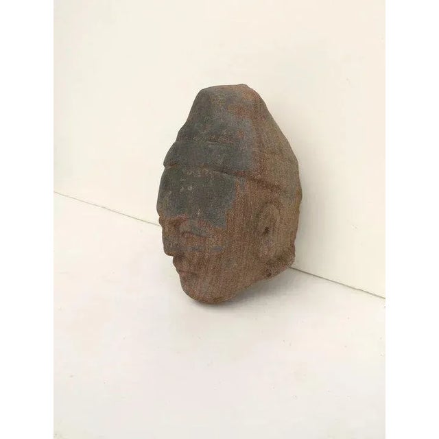 Nicely carved stone fragment of a man in a cap. Measures 5 1/2" tall. B.2604