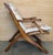 This 1930s French wooden folding armchair blends decorative craftsmanship with practical ingenuity, offering a refined...