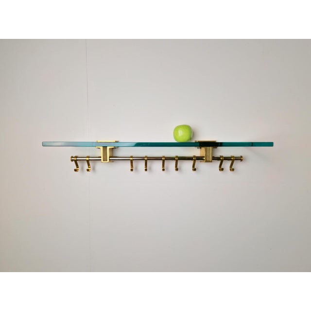 R14G Brass and glass wall mounted coatrack by Peter Ghyczy, 1980s A brass with glass wall mounted coatrack, design by...