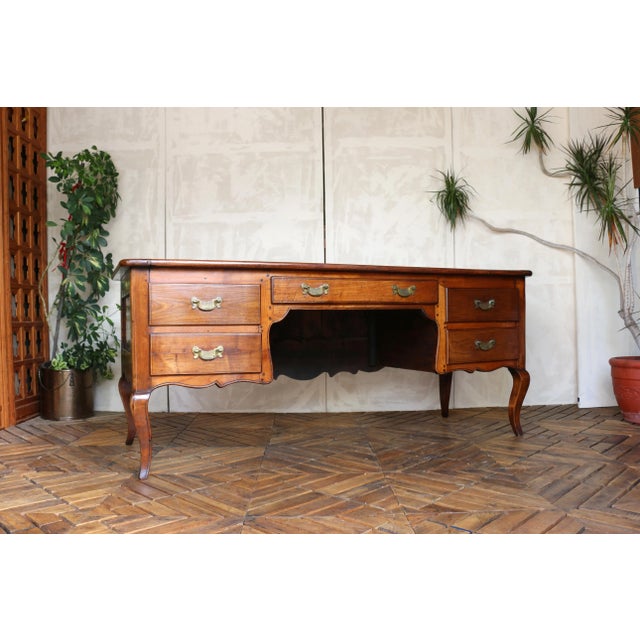 A charming 19th-century Provençal writing desk, exquisitely hand-carved from solid cherrywood. This elegant piece features...