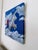 Acrylic painting depicting a silver inflatable unicorn suspended within a deep blue sky populated by layered cloud...