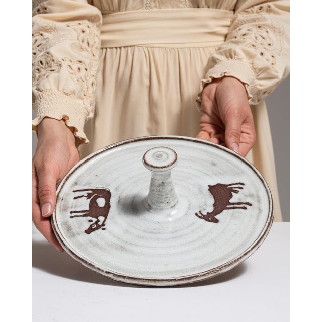 This 1970s platter from Germany is finished in white, worked in ceramic. Its signed detailing gives the piece a distinct,...